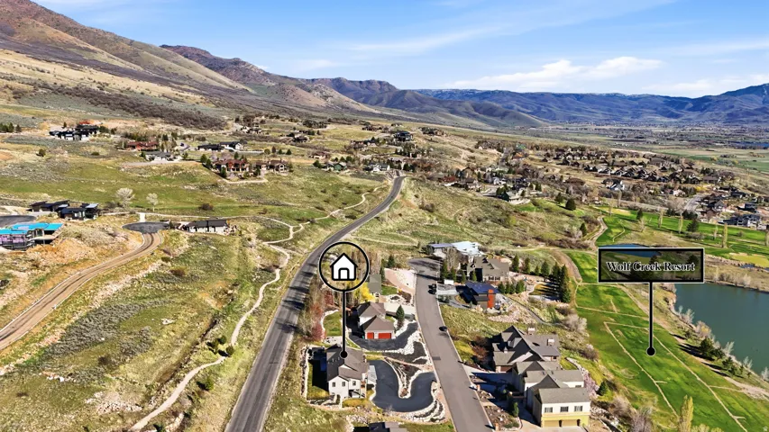 Aerial view of property and surrounding area with nearby suburban area and a water and mountain view