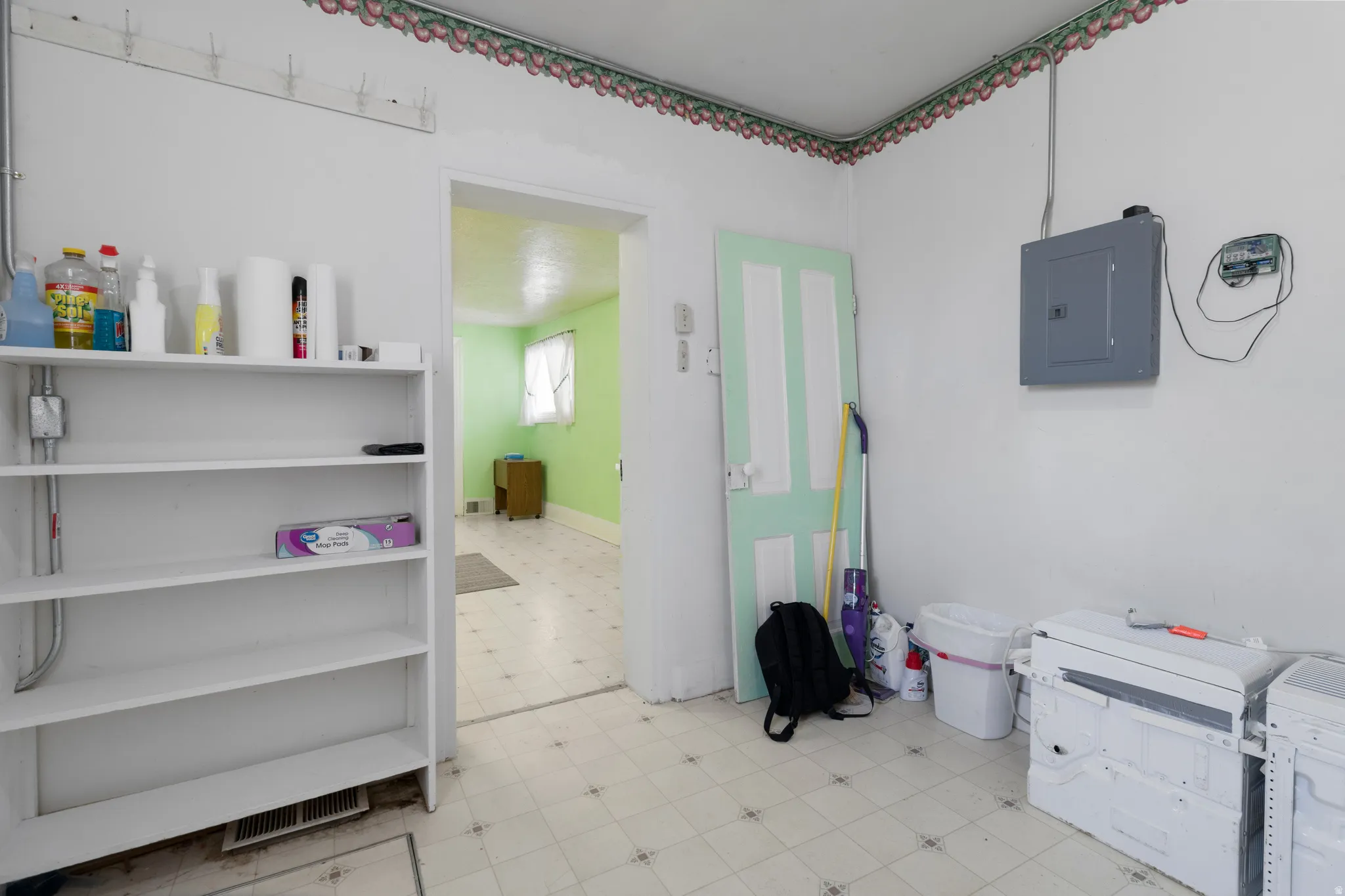 Interior space featuring light flooring and electric panel