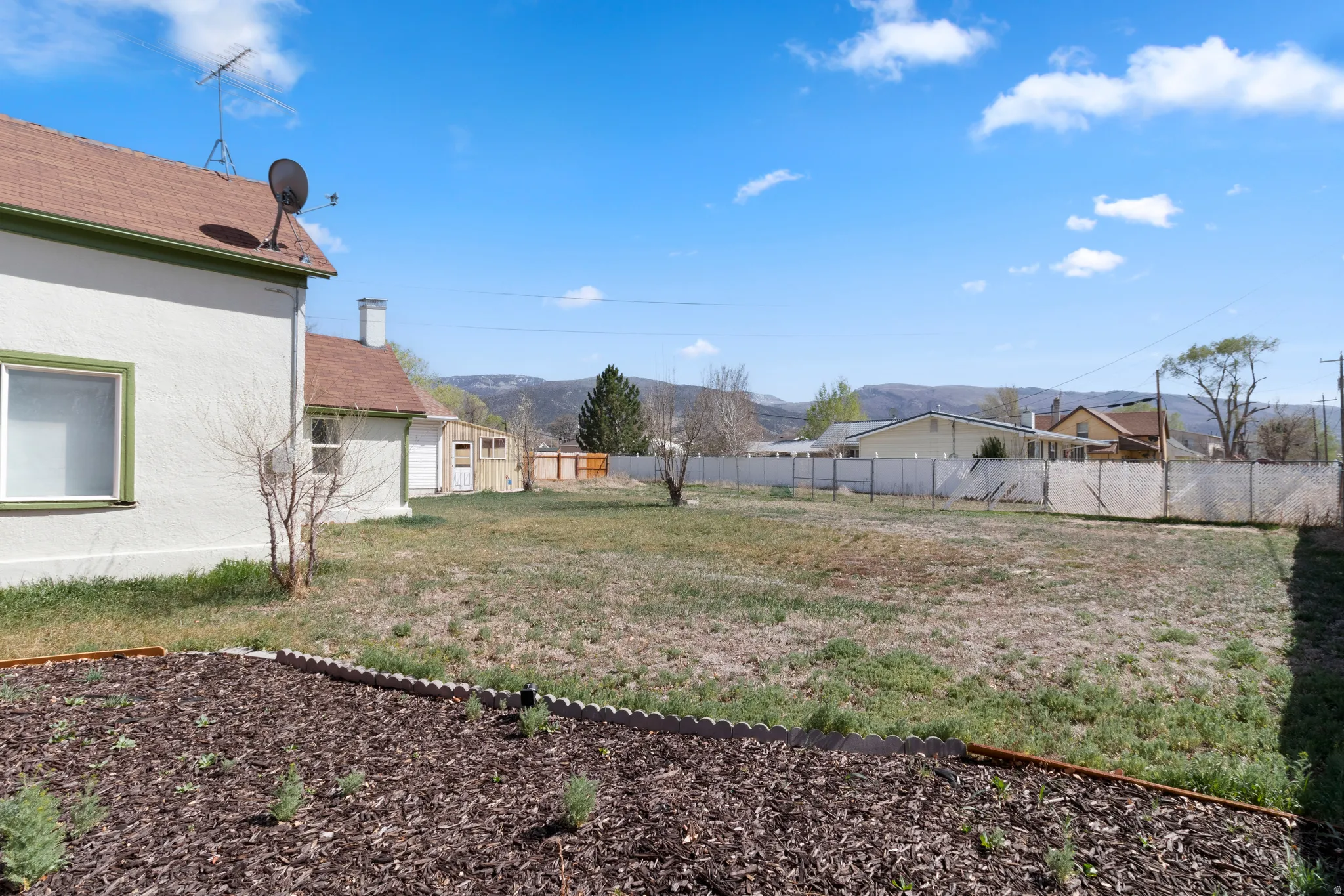 Fenced backyard featuring a mountain view
