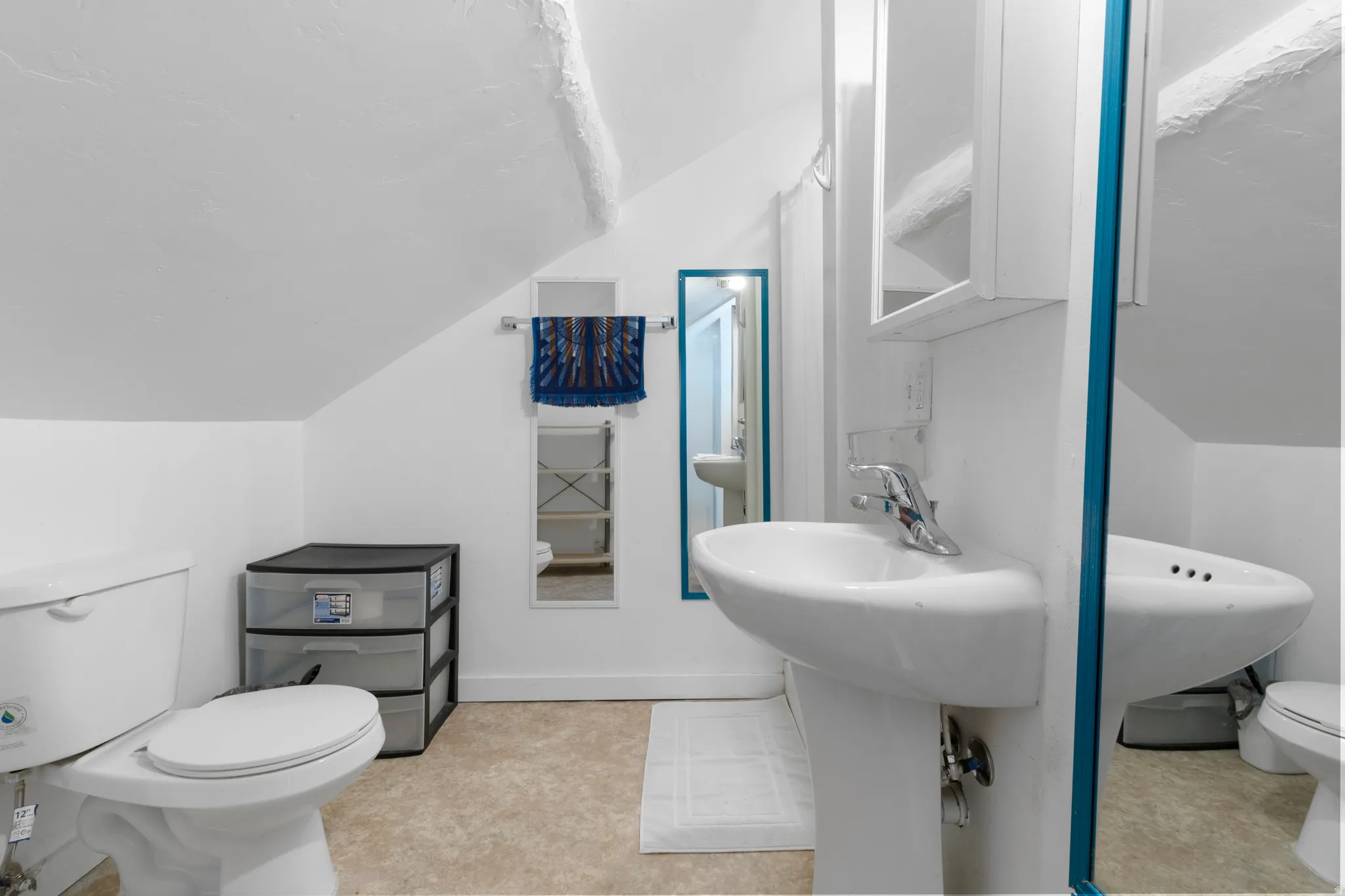 Half bathroom with toilet and lofted ceiling