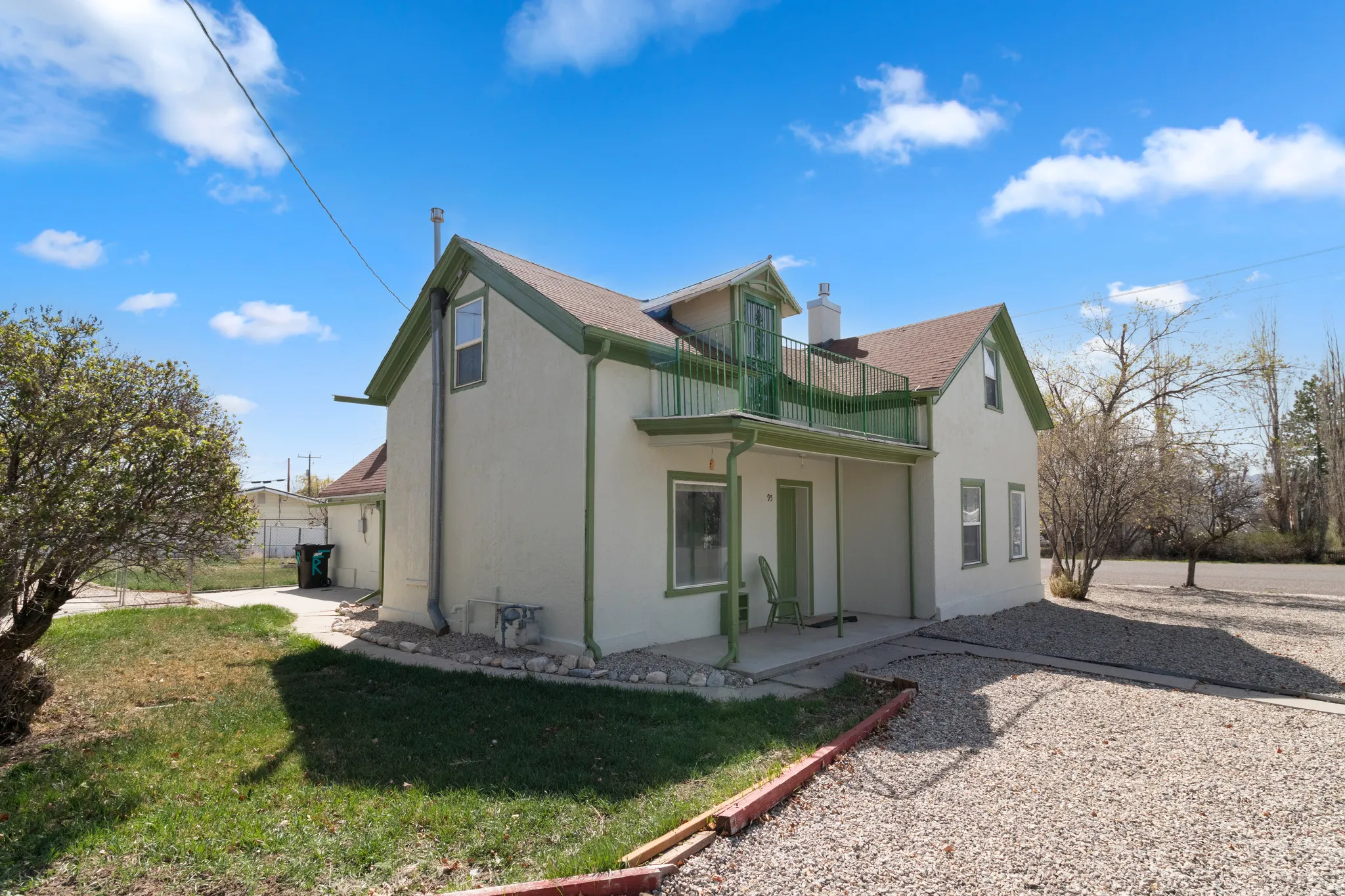 Rear view of property with a patio, a lawn, and stucco siding