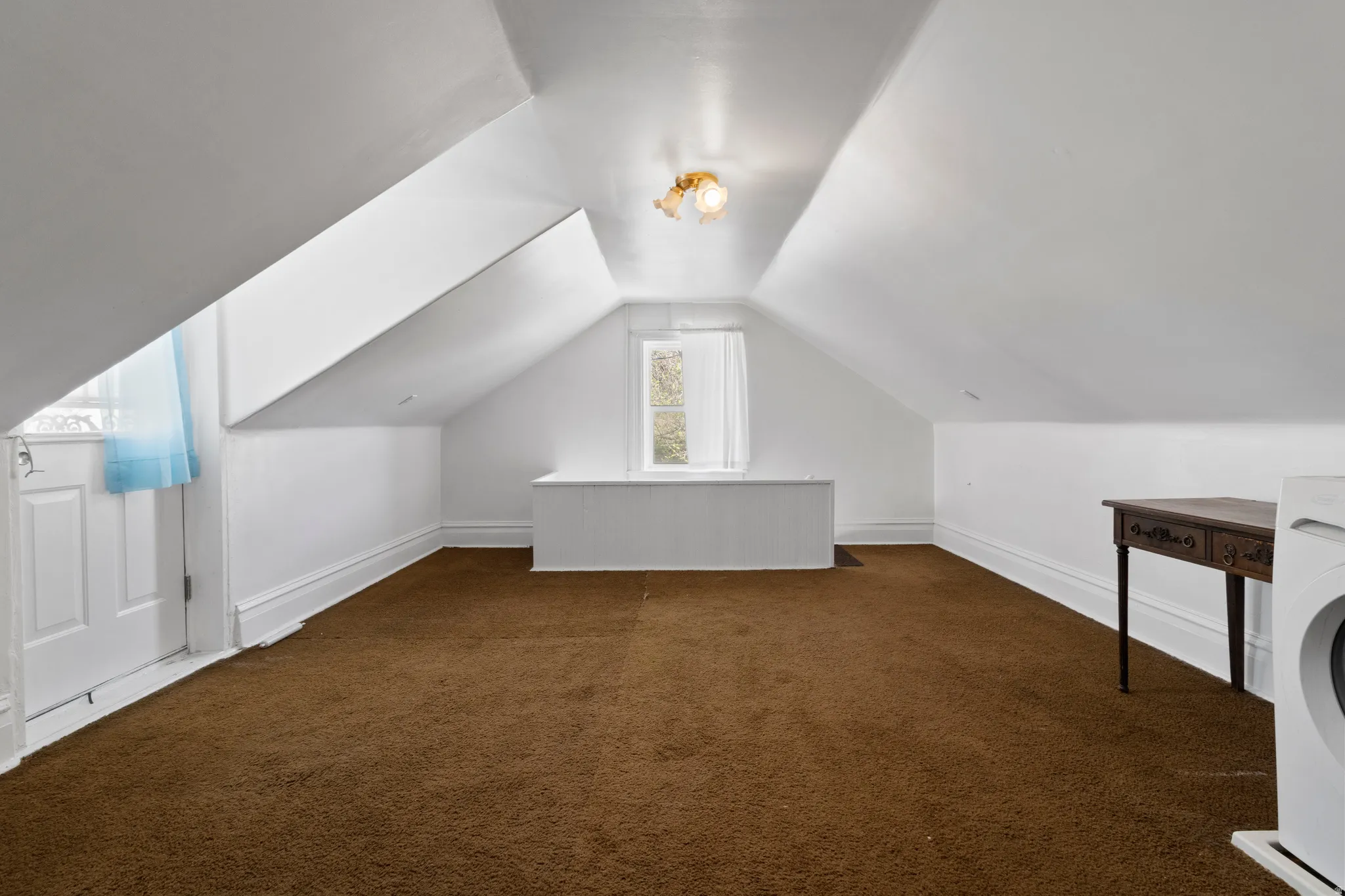 Additional living space with dark carpet and washer / clothes dryer