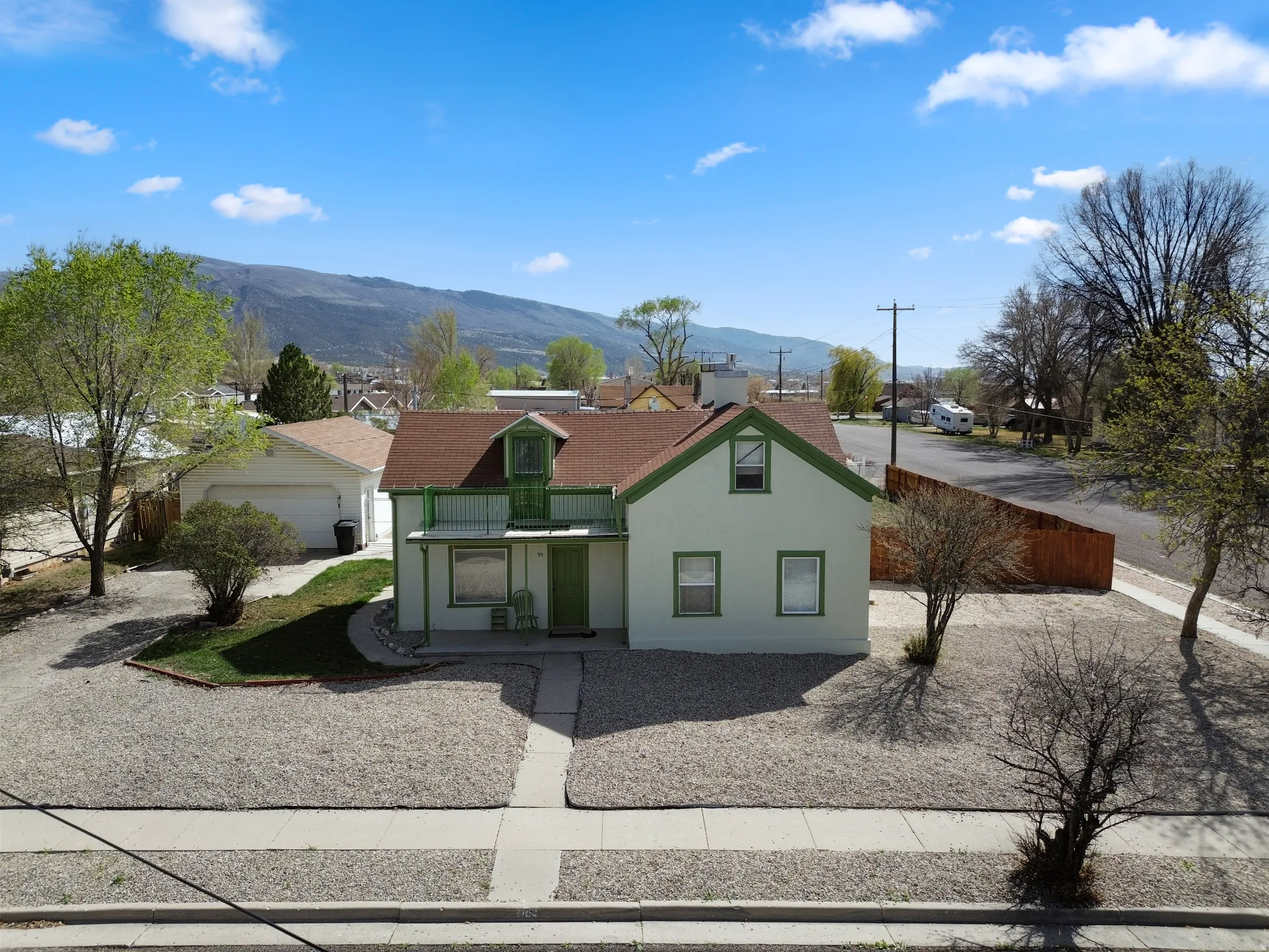 View of front facade featuring a balcony, stucco siding, and a mountain view