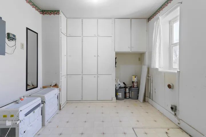 Laundry room featuring light floors and cabinet space