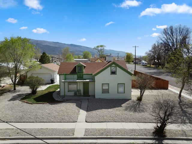 View of front facade featuring a balcony, stucco siding, and a mountain view