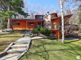 Classic mountain home with 3 floors, large, beautiful yard, 2 masonry stone fireplaces, 5 bedrooms, 4 baths, large, wrap-around deck. Perfect location!