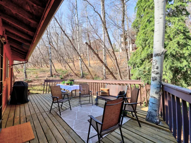 Large deck with an outdoor seating, dining, and room for a hot tub