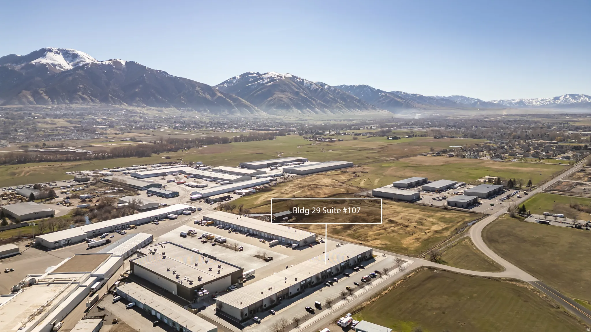 Drone / aerial view of a mountain backdrop and industrial structures