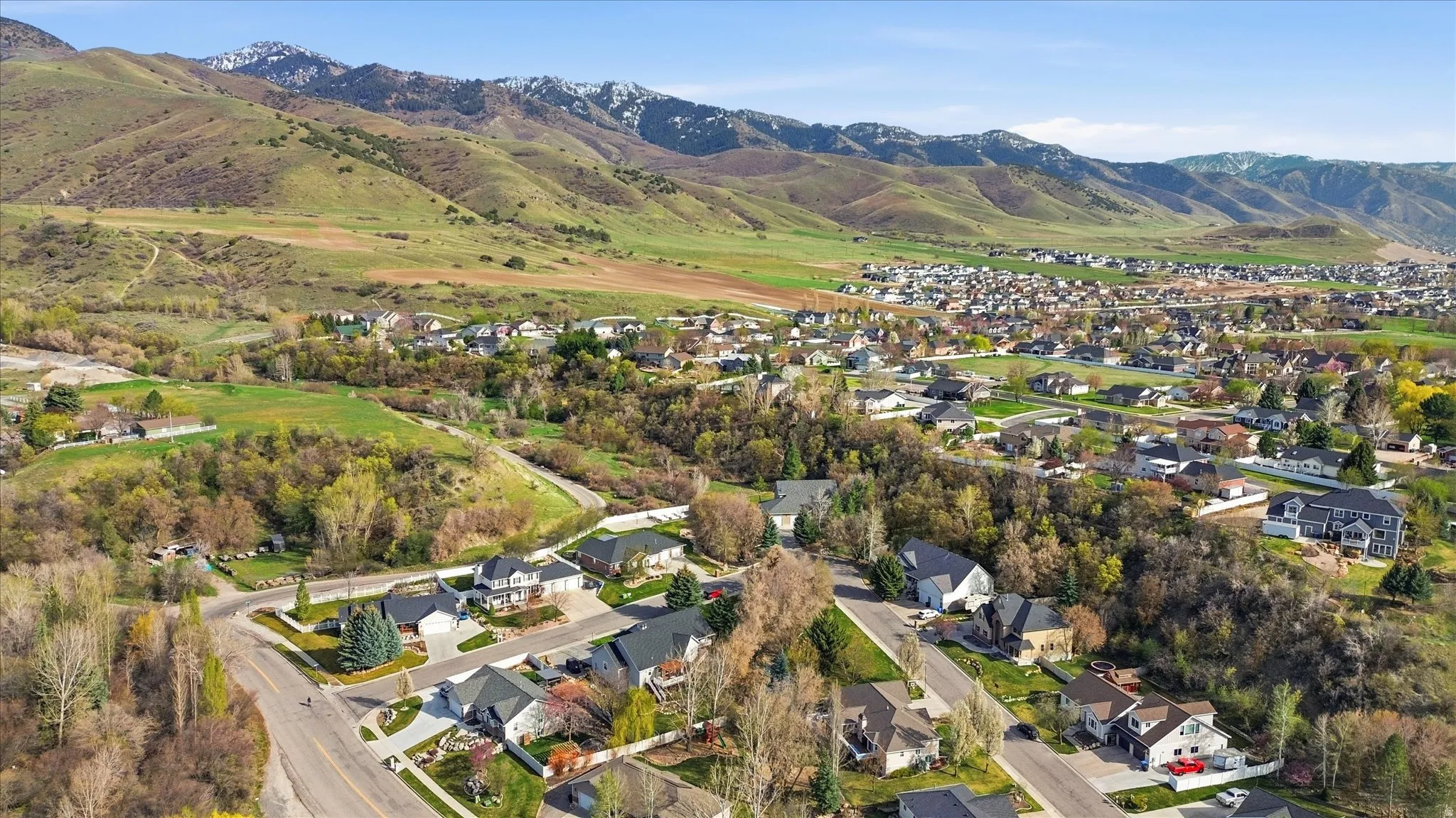 Aerial perspective of suburban area with a mountainous background