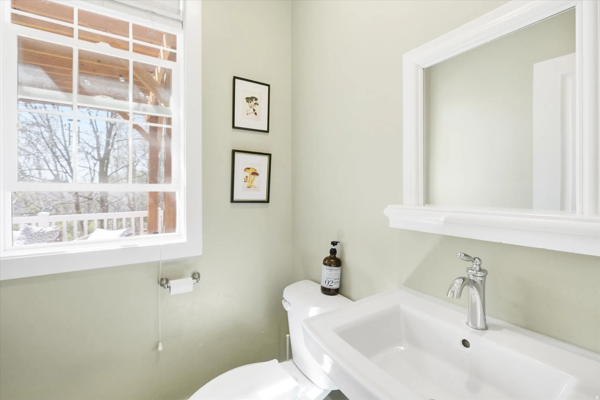 Half bathroom featuring toilet and a sink