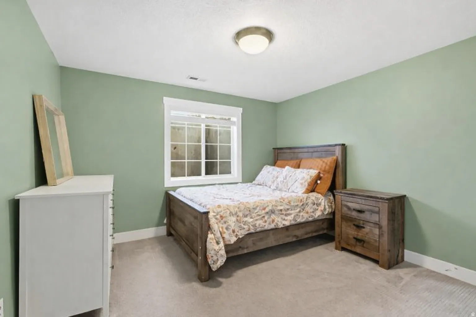 Bedroom featuring baseboards and light carpet