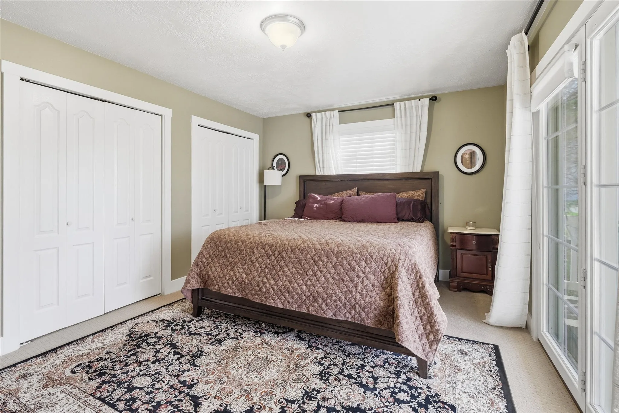 Carpeted bedroom with two closets
