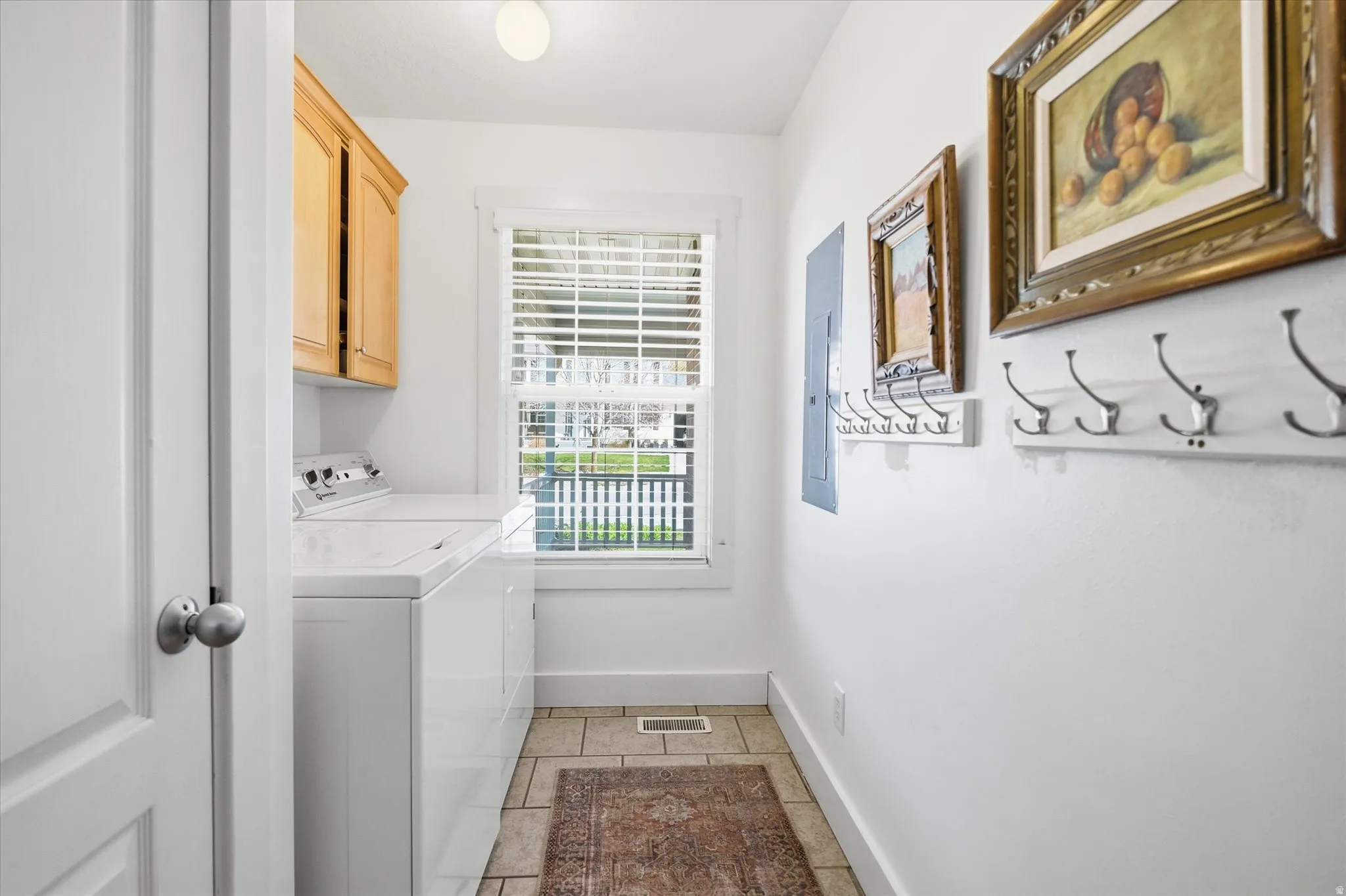 Laundry room with cabinet space and independent washer and dryer