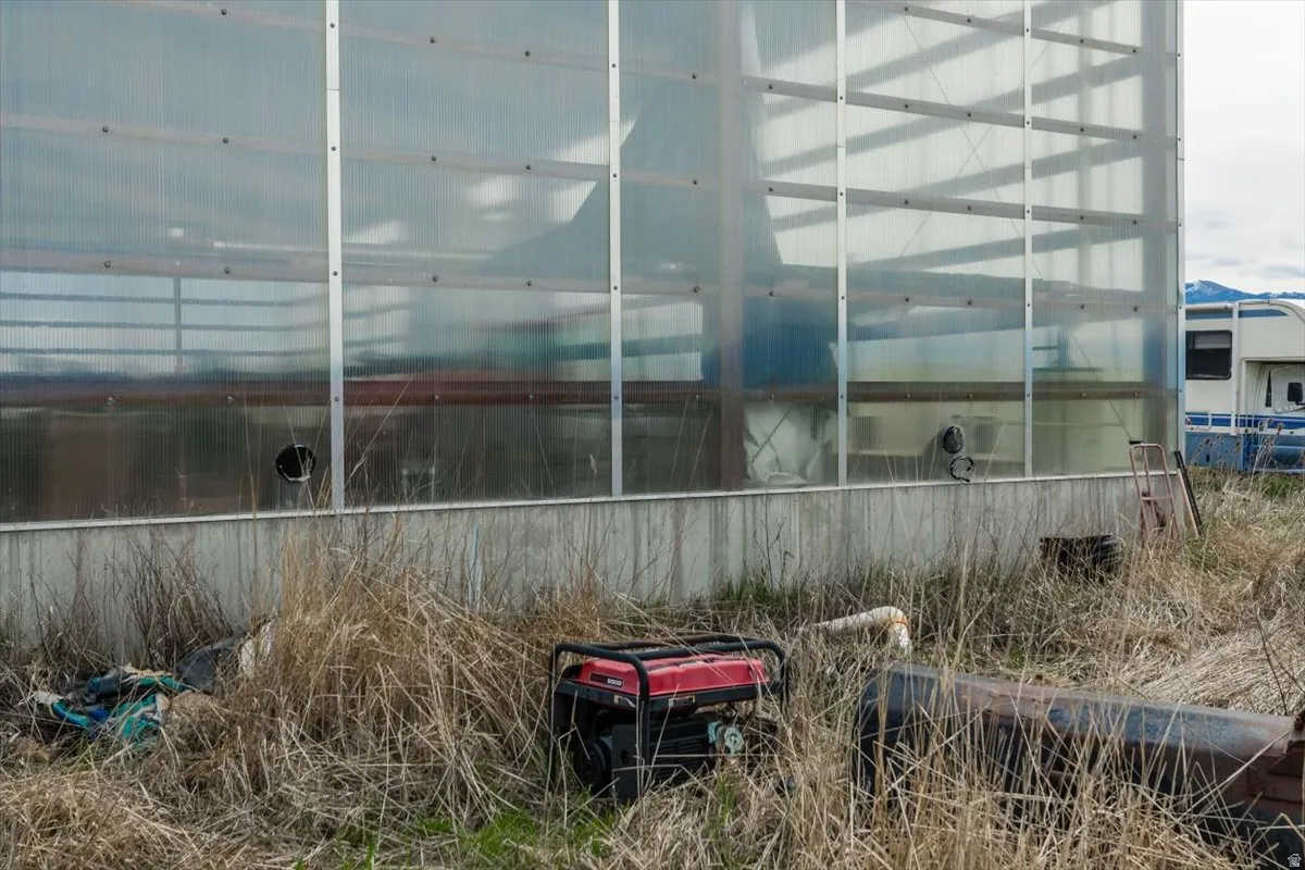 View of side of property with an exterior structure and an outbuilding