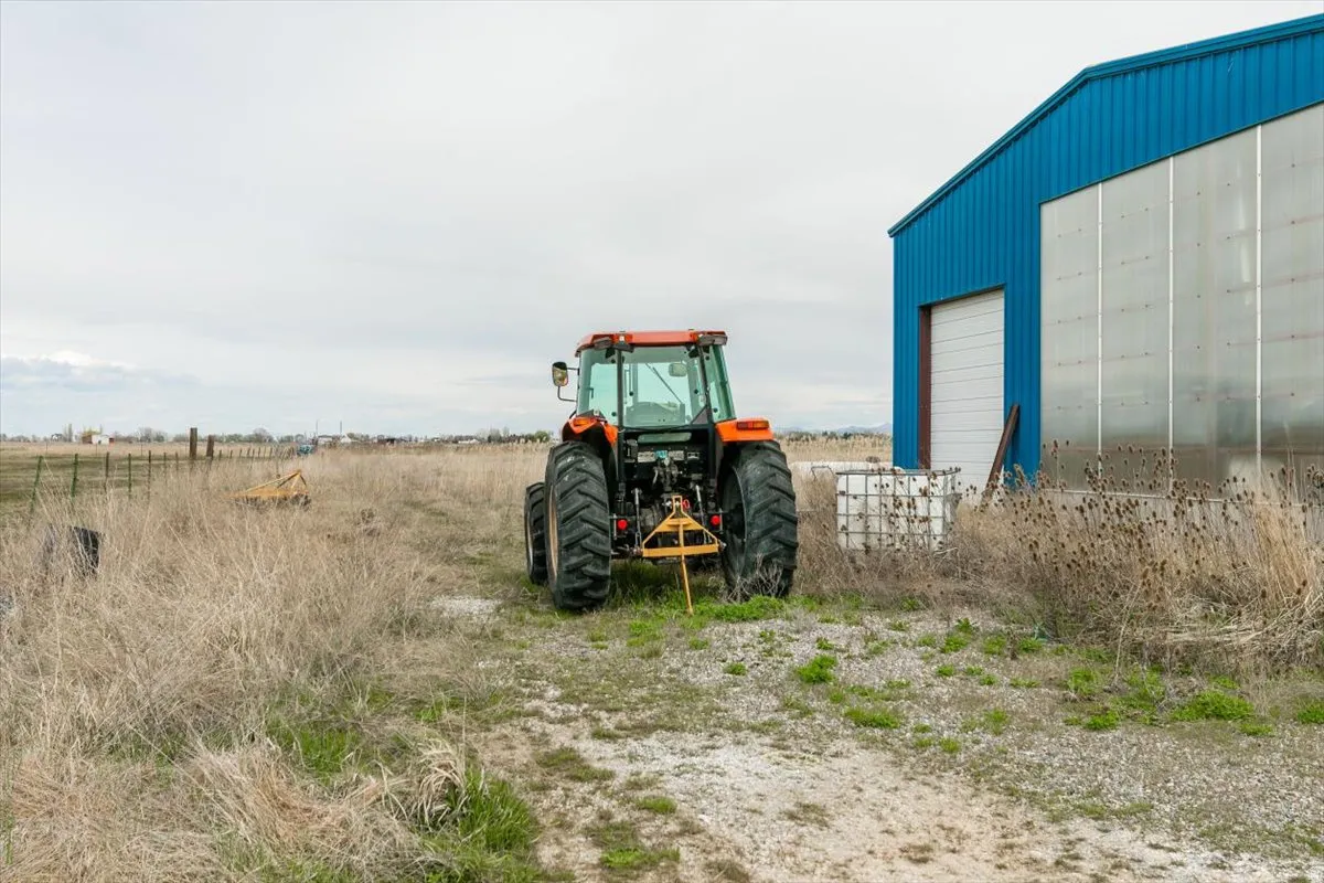 View of yard with an outdoor structure, a view of countryside, and a garage