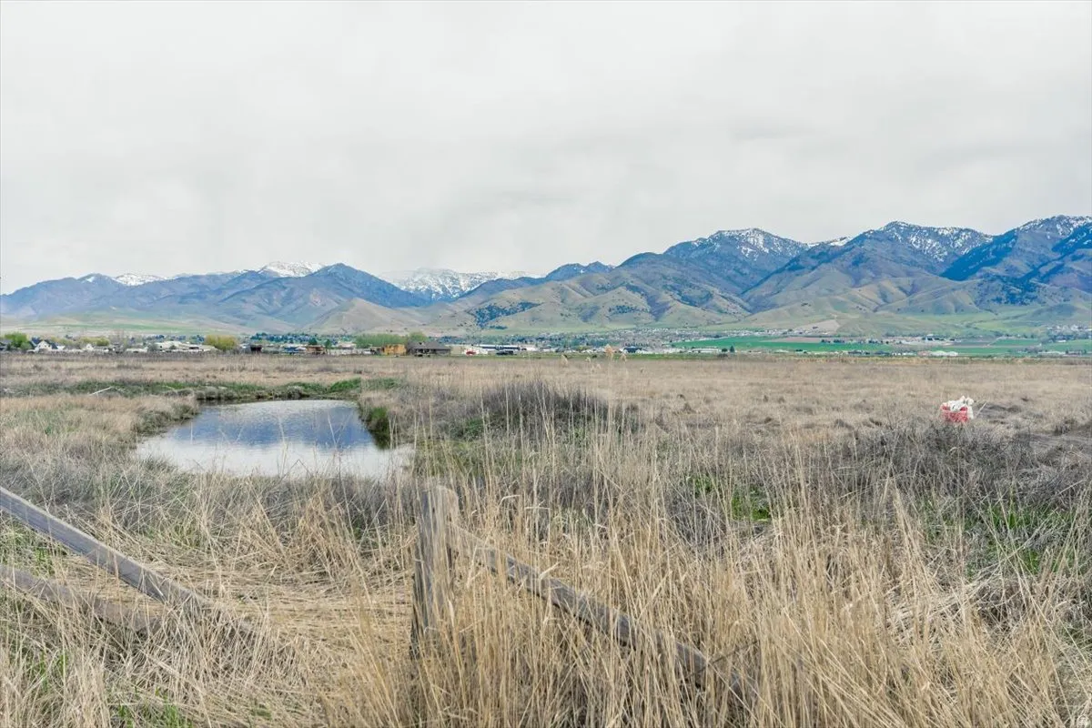 View of mountain background with a nearby body of water and rural landscape