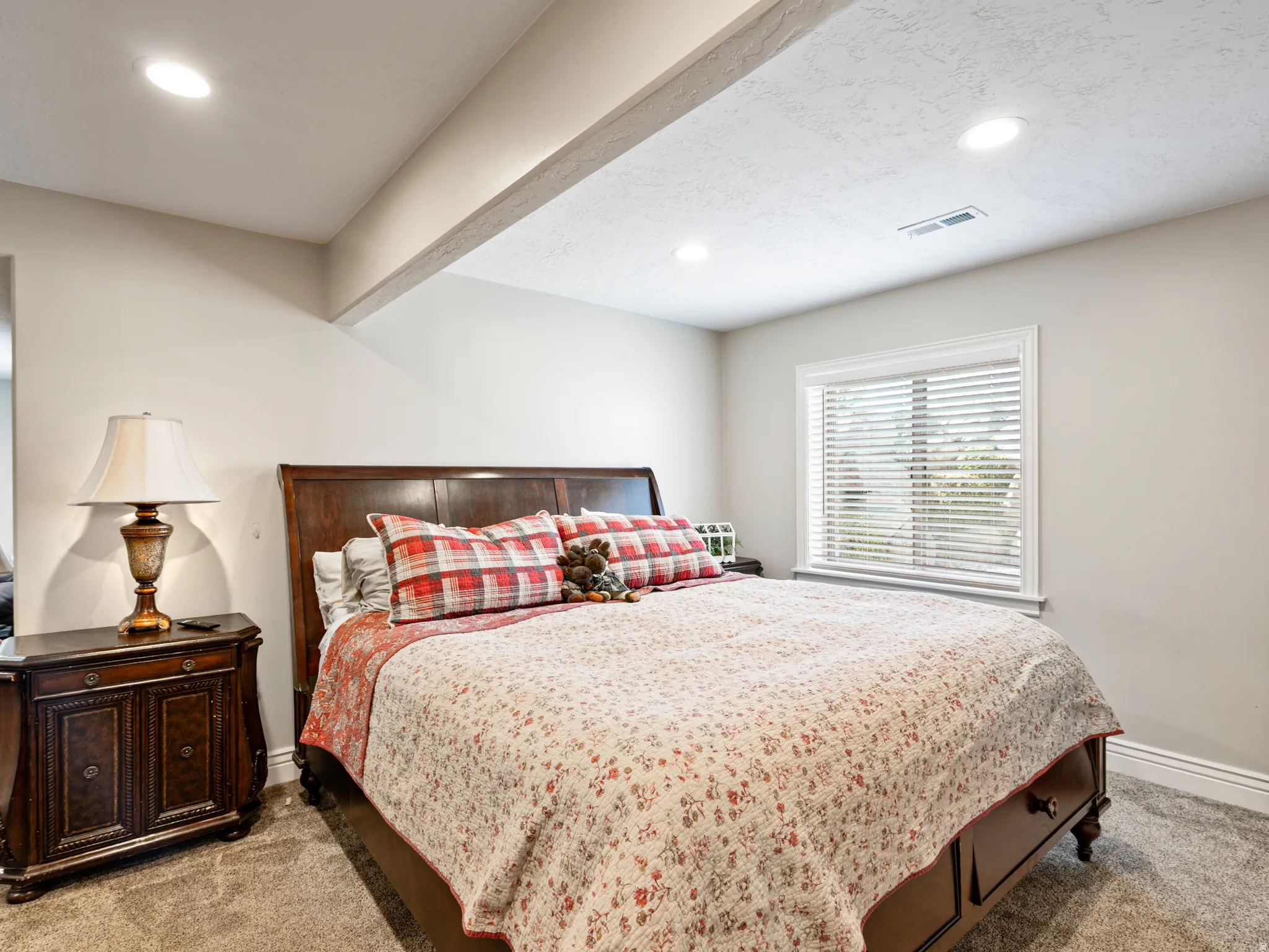 Bedroom with light colored carpet and recessed lighting