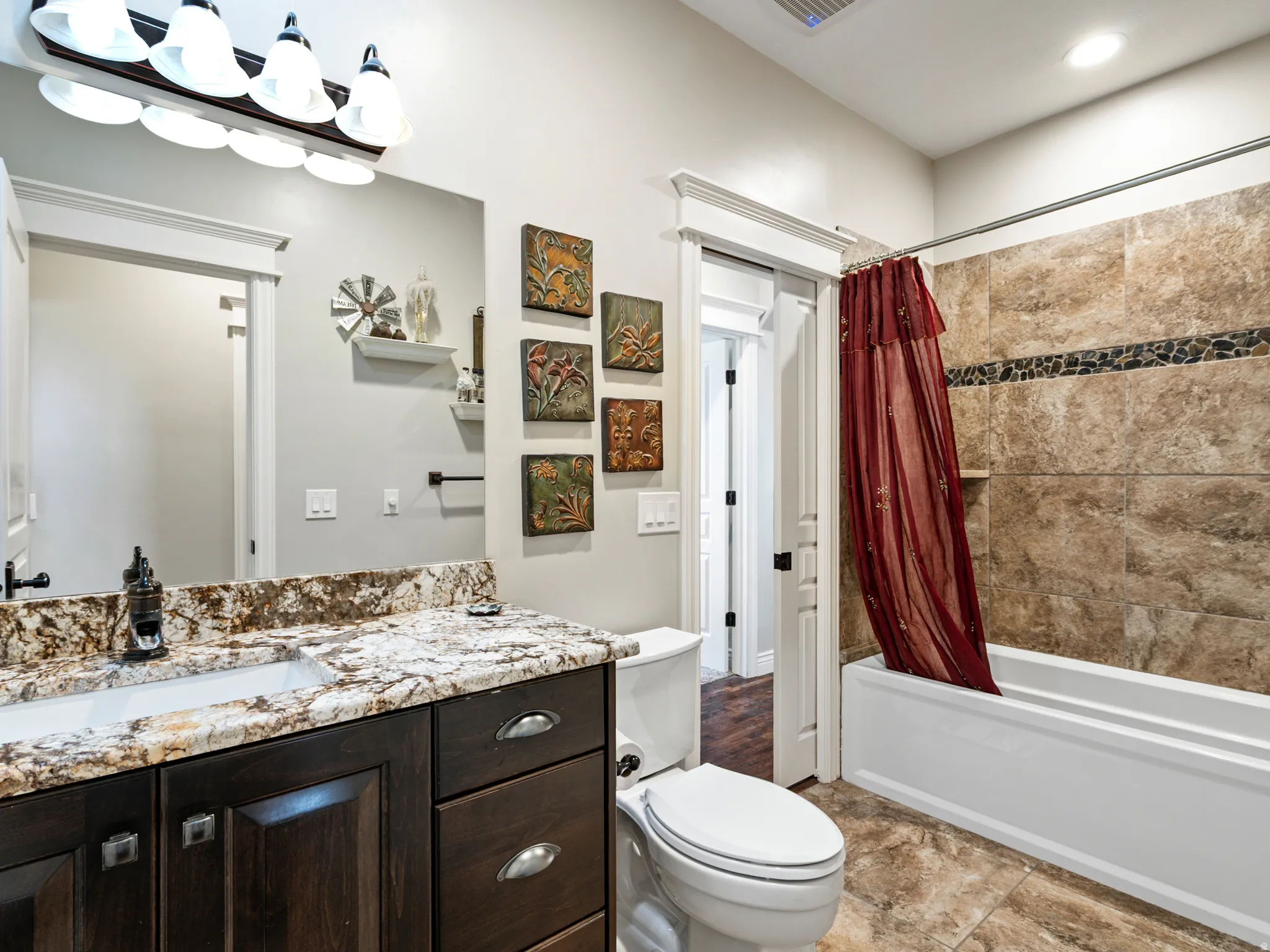 Full bath featuring shower / bathtub combination with curtain and vanity