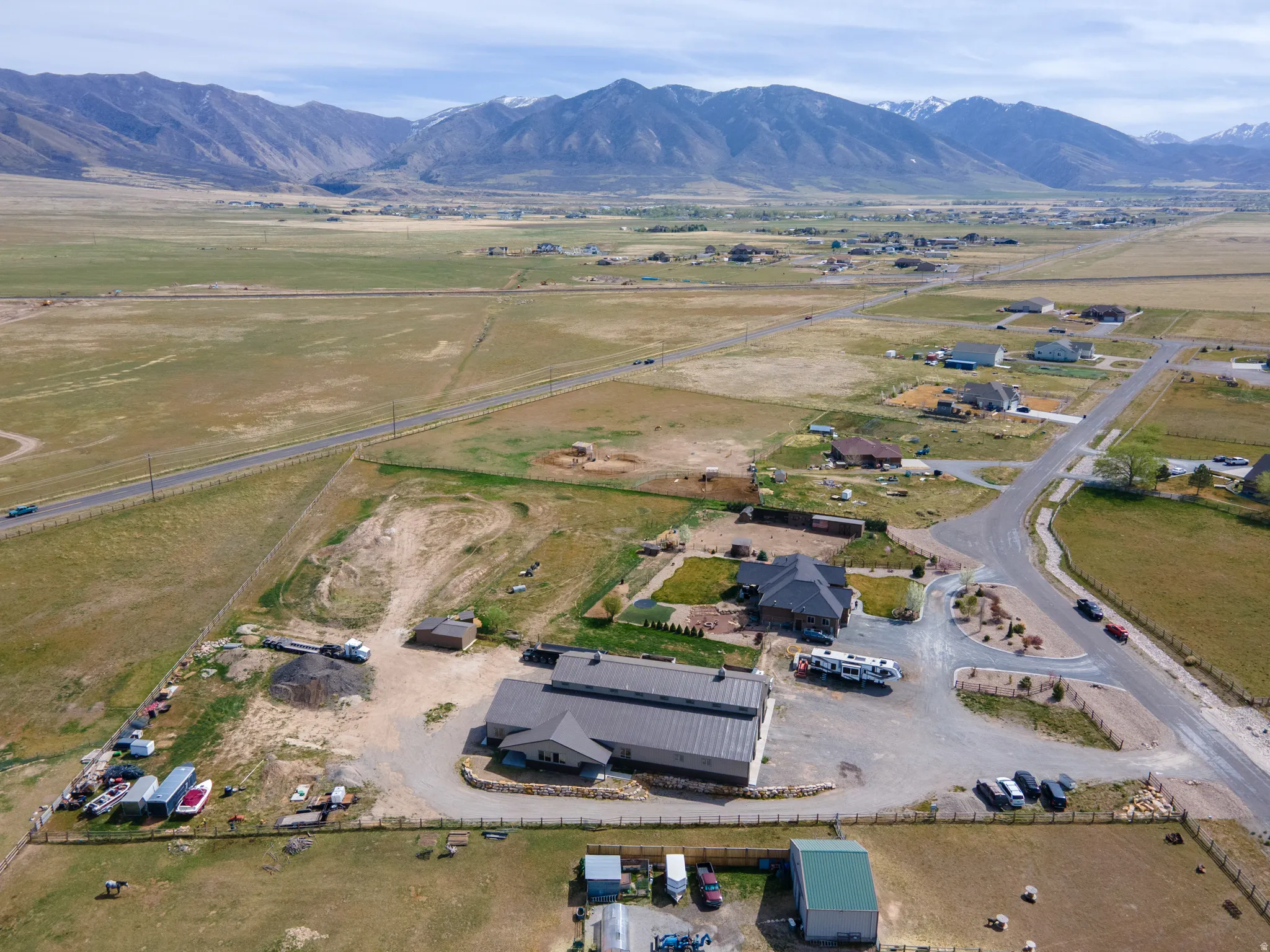 Aerial view of property and surrounding area with rural landscape and a mountainous background
