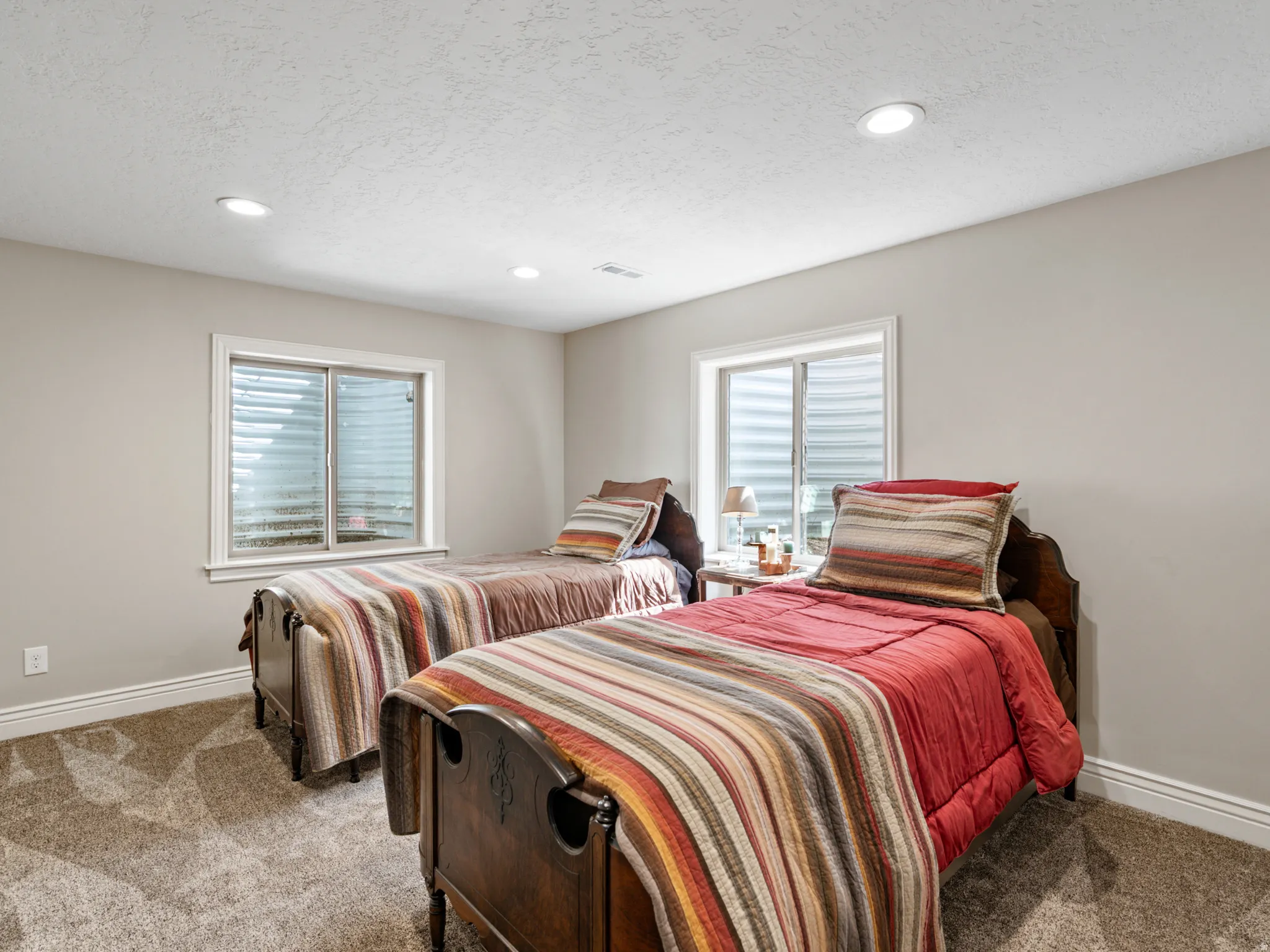 Bedroom featuring recessed lighting, carpet, and a textured ceiling
