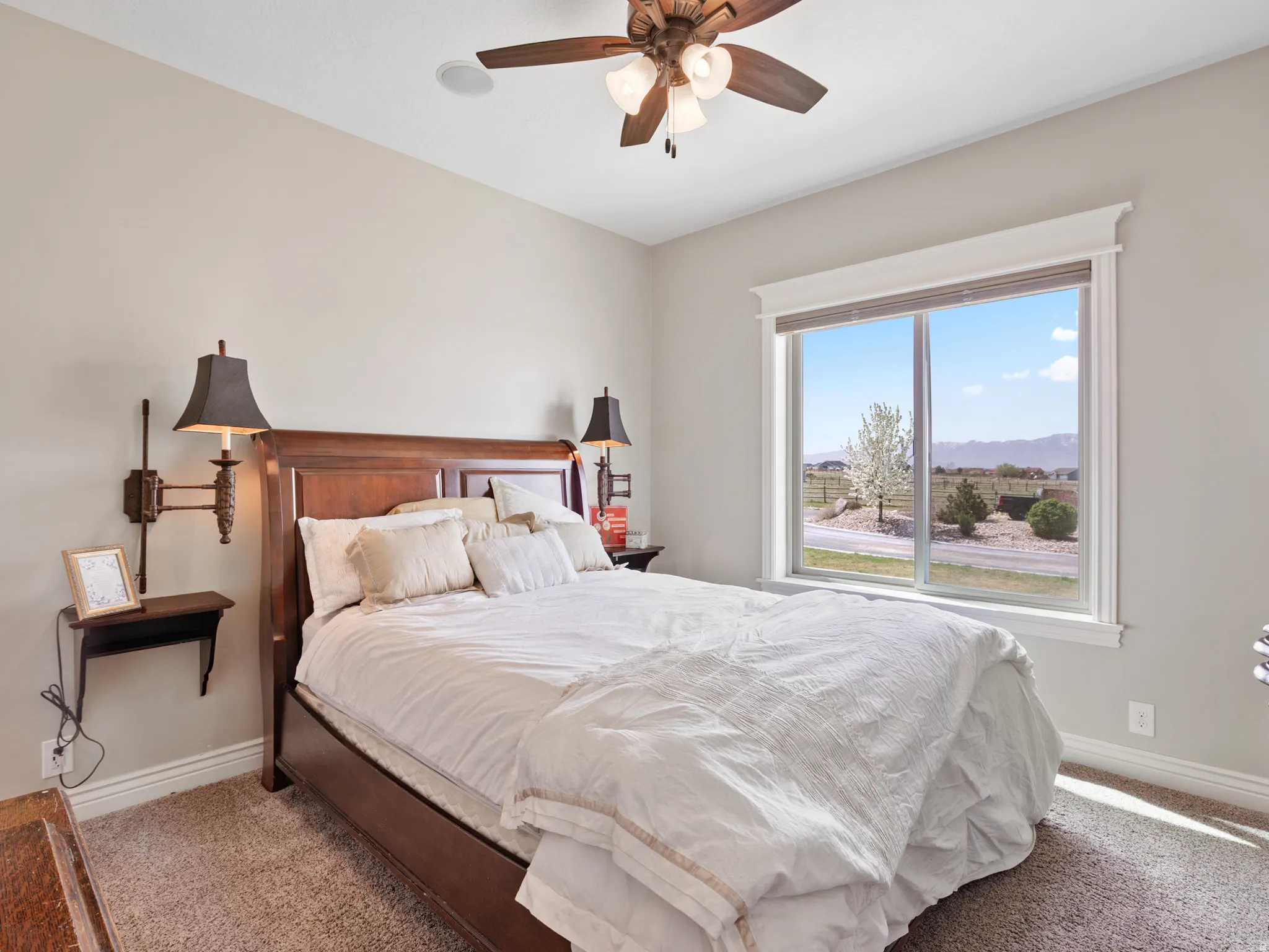 Bedroom featuring a mountain view, carpet, and ceiling fan
