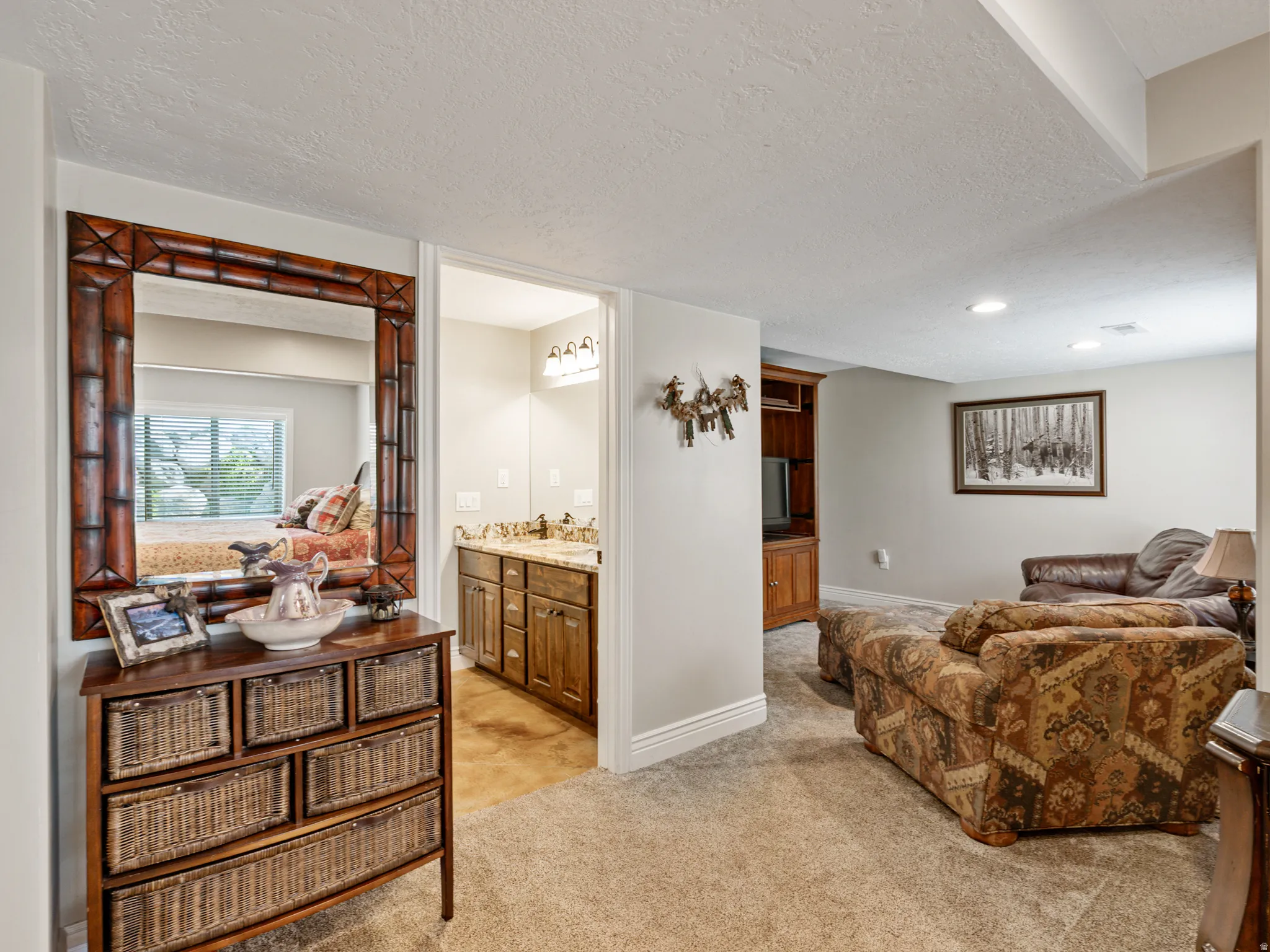 Living area featuring a textured ceiling and light colored carpet