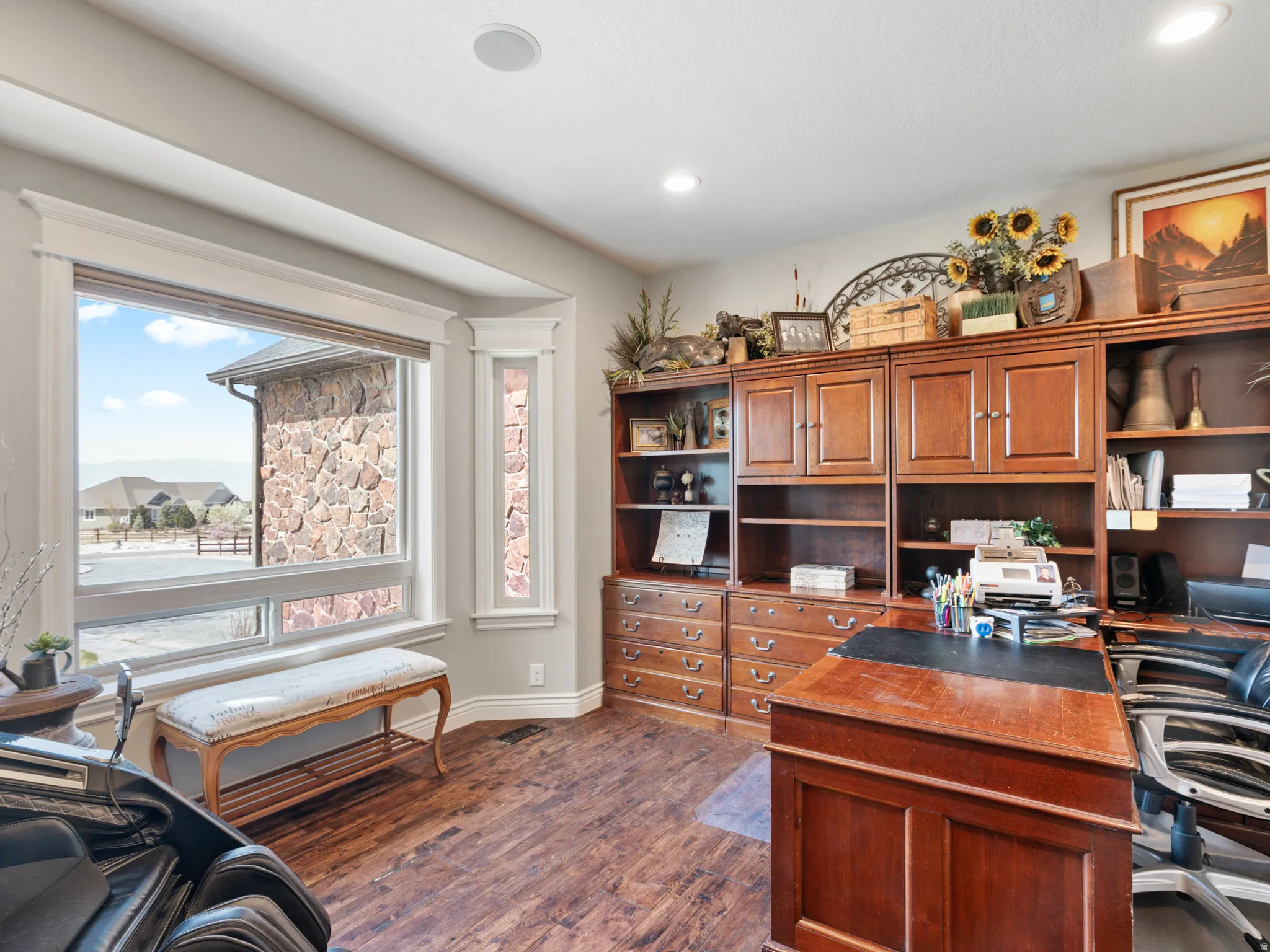 Office space with dark wood finished floors and recessed lighting