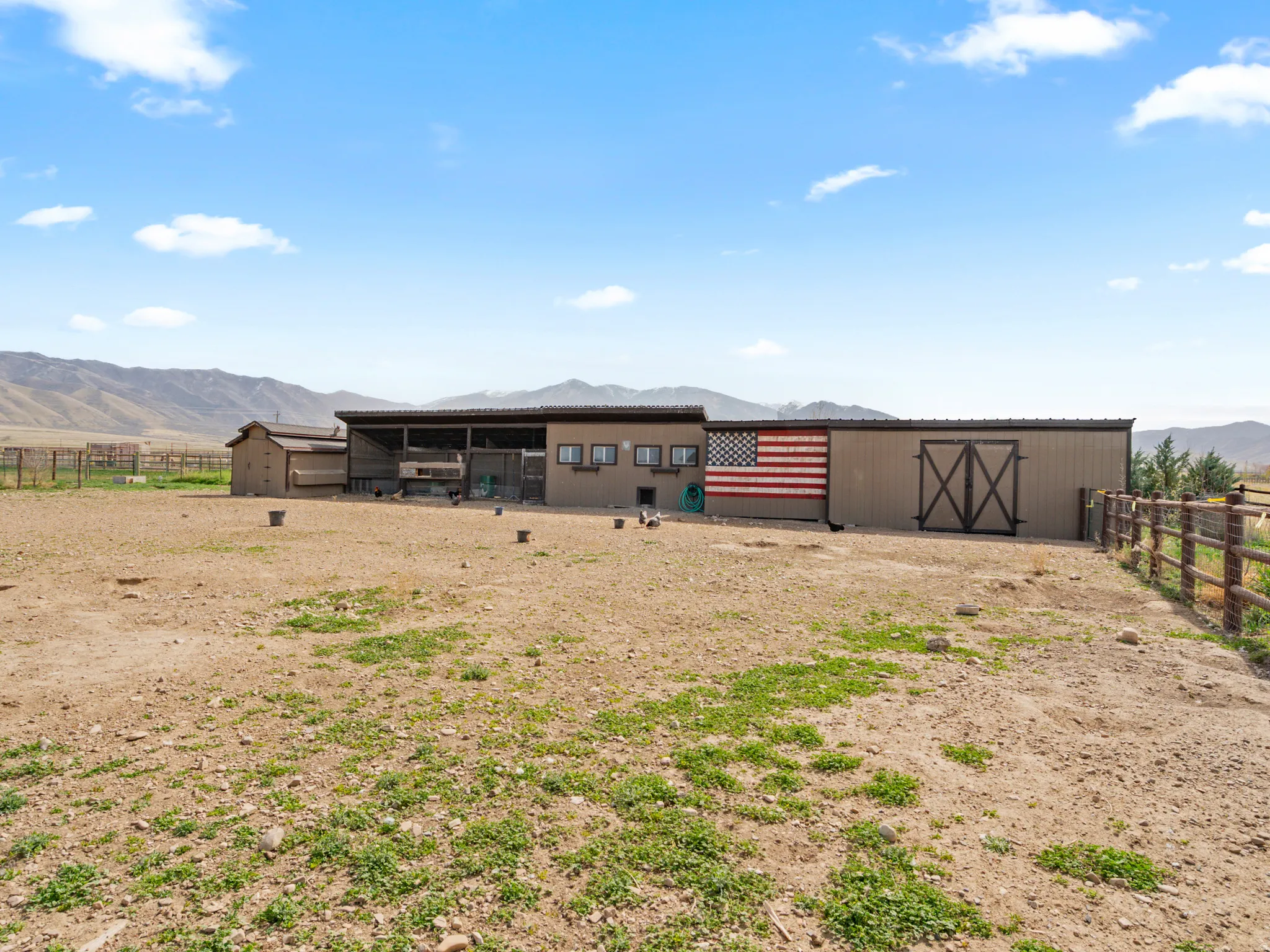Back of house featuring an outdoor structure, a mountain view, and an exterior structure