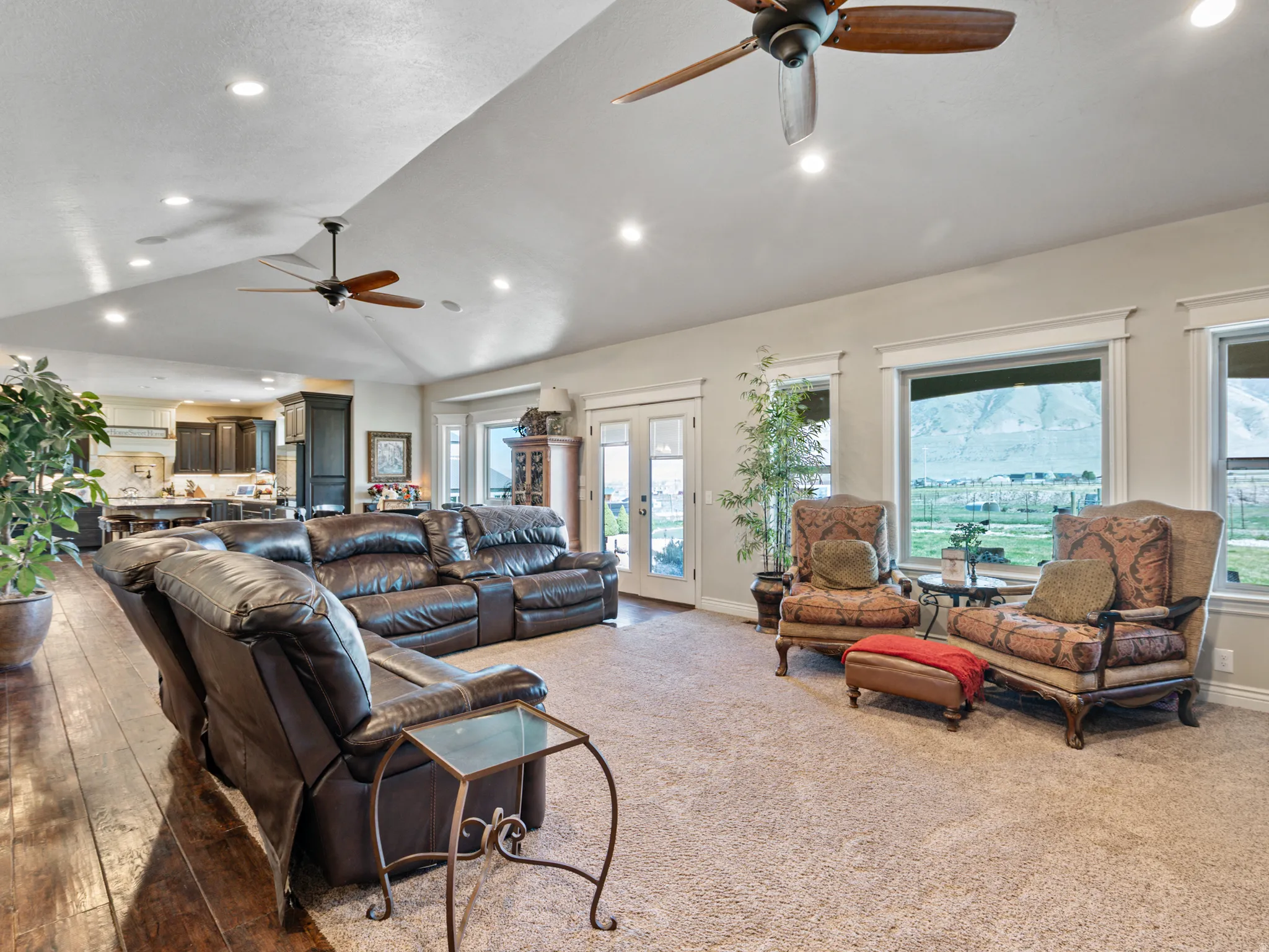 Living area featuring a ceiling fan, french doors, recessed lighting, and lofted ceiling
