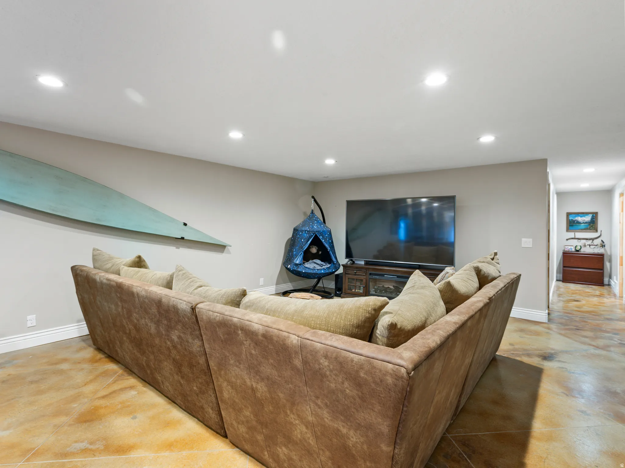 Living room featuring finished concrete flooring and recessed lighting