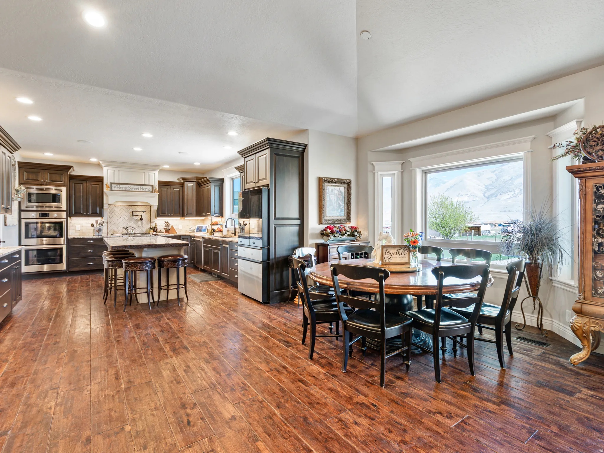 Dining space with dark wood-style floors and recessed lighting
