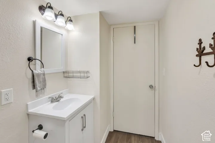 Contemporary bathroom vanity featuring a white countertop and integrated sink