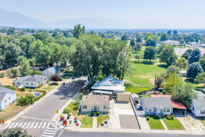Aerial perspective showcasing a residential street with single-story homes and mature landscaping