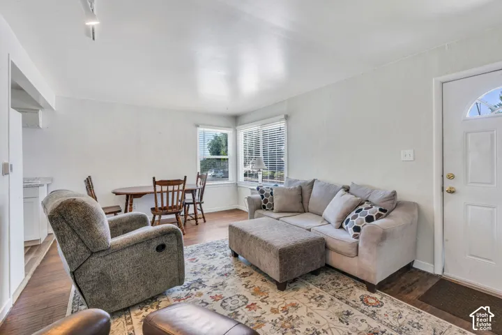 Bright living area featuring wood-finish flooring, white walls, and track lighting