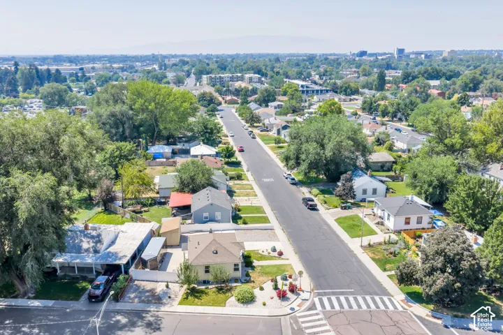 Aerial perspective of a residential street featuring established homes and mature trees