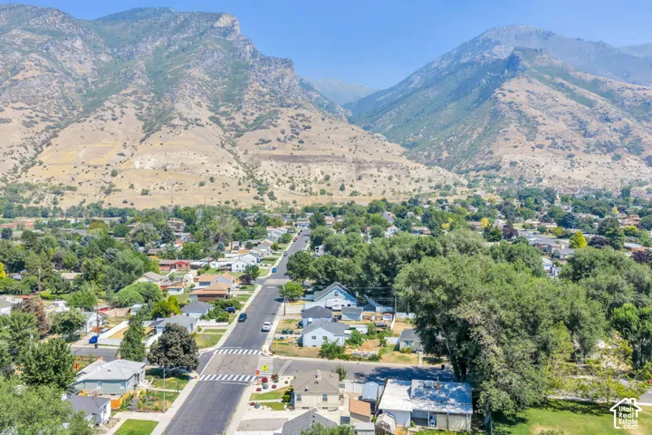 Residential neighborhood featuring an array of single-family homes, mature trees, and paved streets with crosswalks