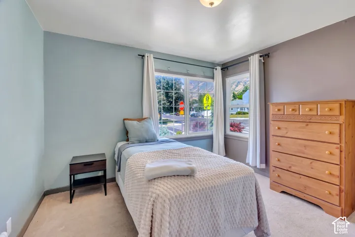Bedroom featuring light blue and gray walls