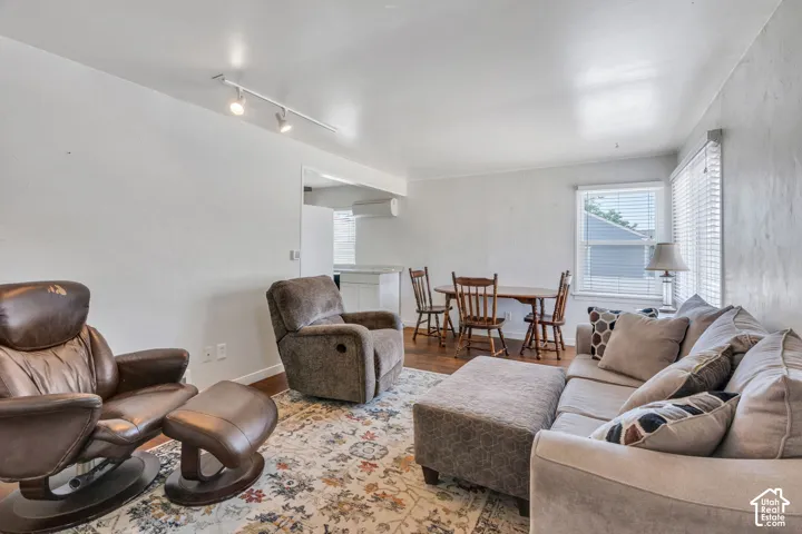 Living area featuring wood-finish flooring and track lighting