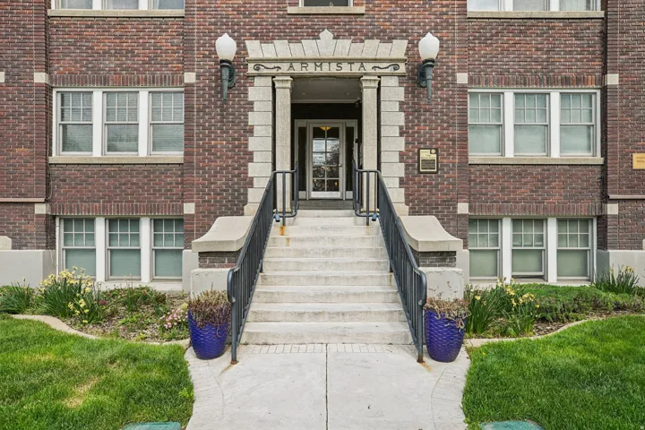 Property entrance featuring brick siding
