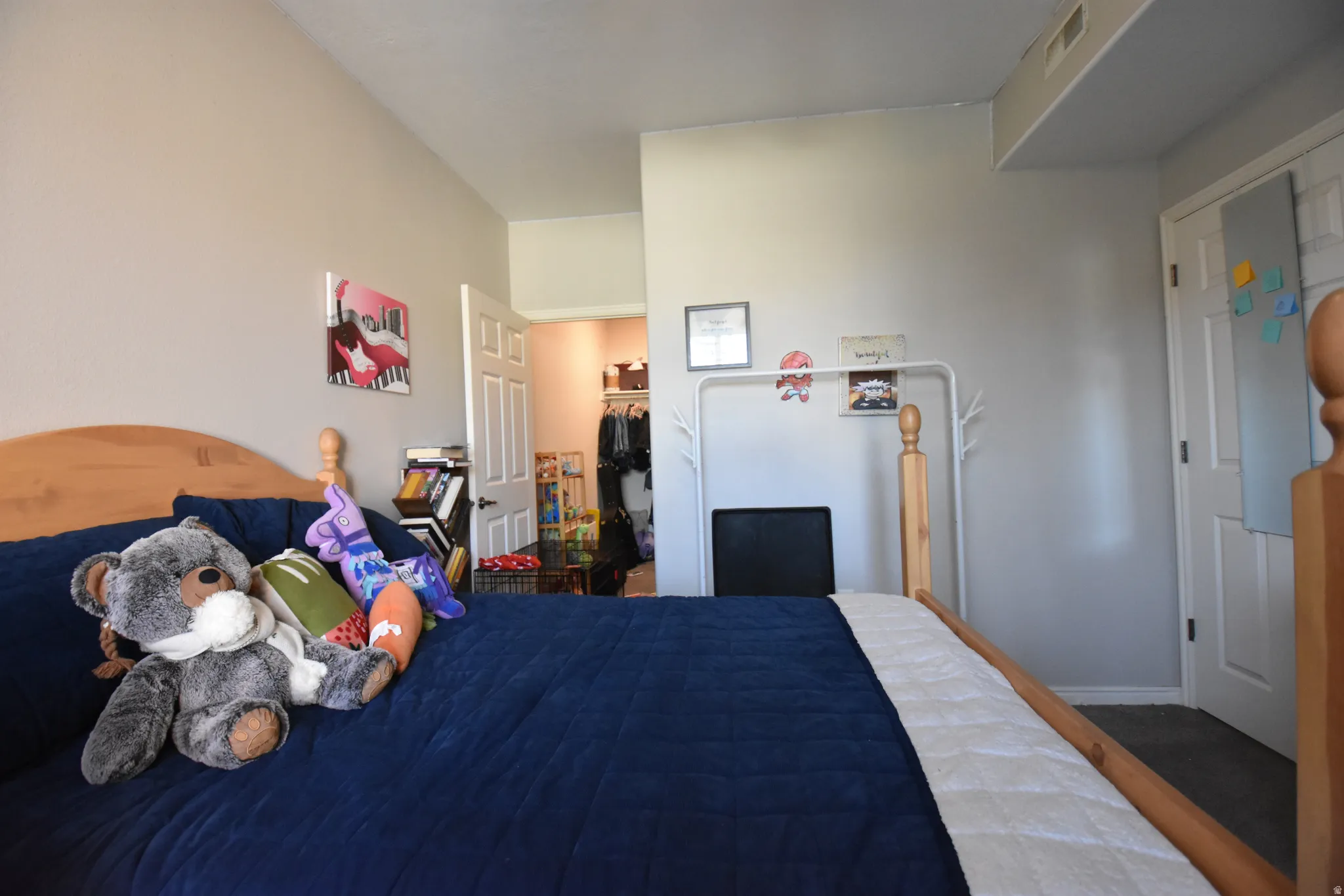 Bedroom with a walk in closet and baseboards