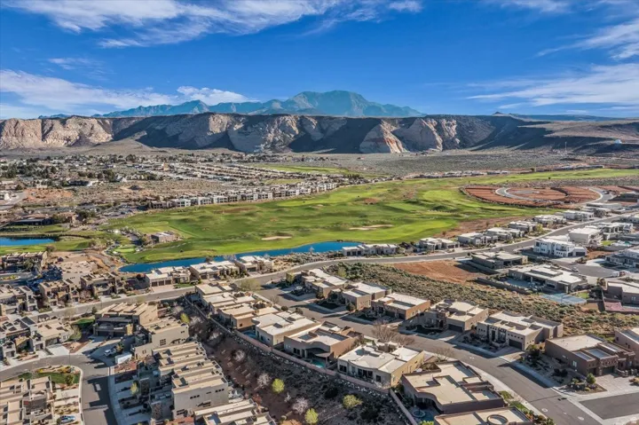 Drone / aerial view of a water and mountain view and a golf course