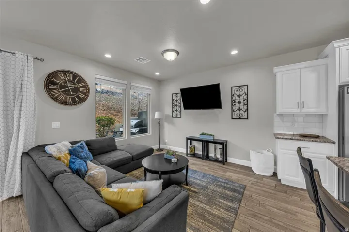 Living area featuring dark wood finished floors and recessed lighting