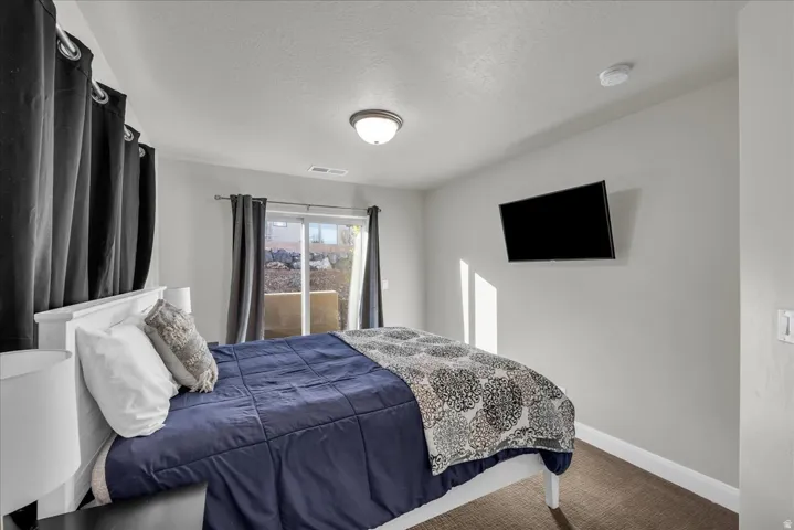 Carpeted bedroom featuring a textured ceiling