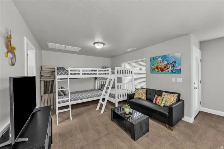 Bedroom with carpet flooring and a textured ceiling