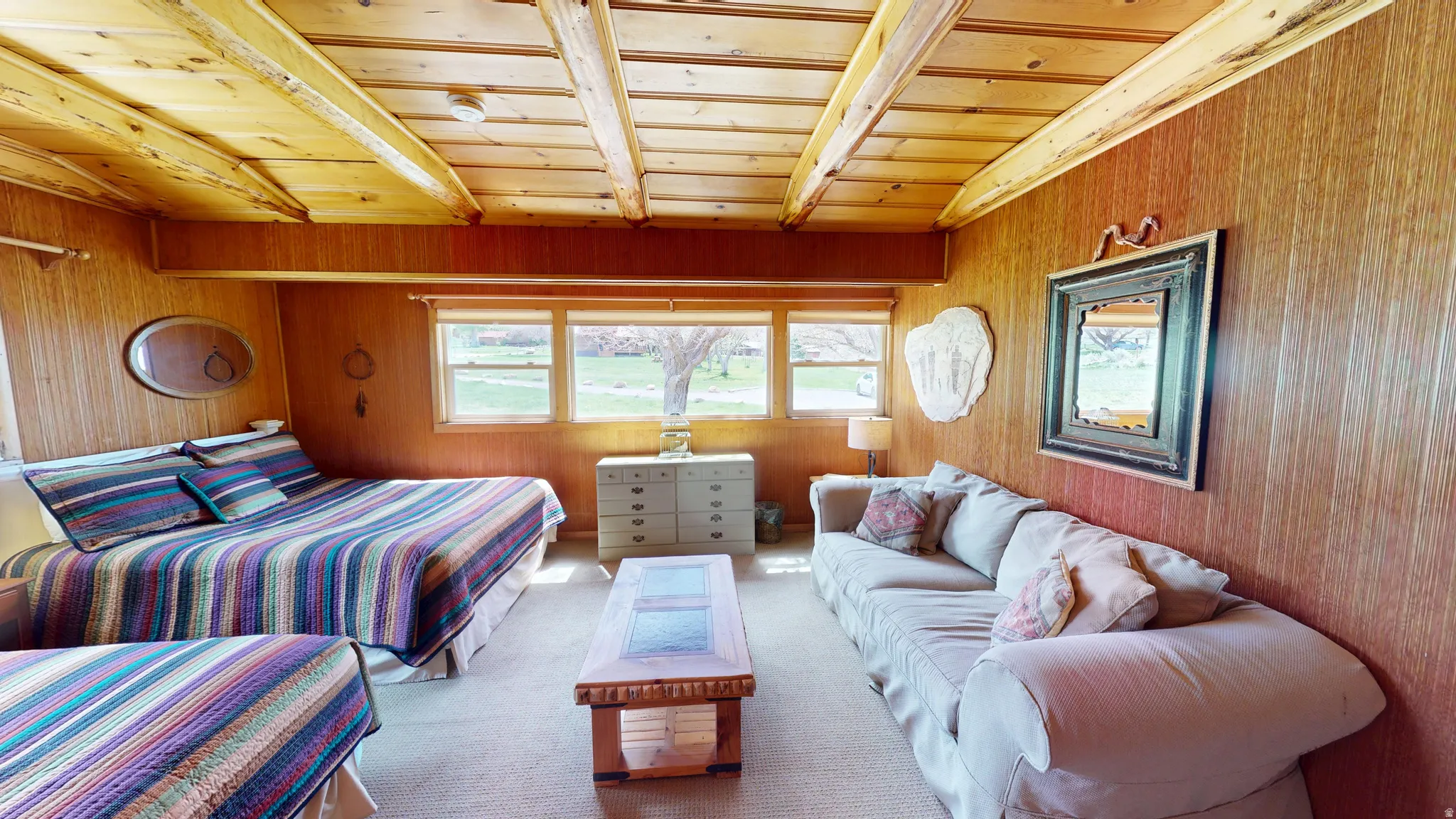 Carpeted bedroom featuring wooden walls