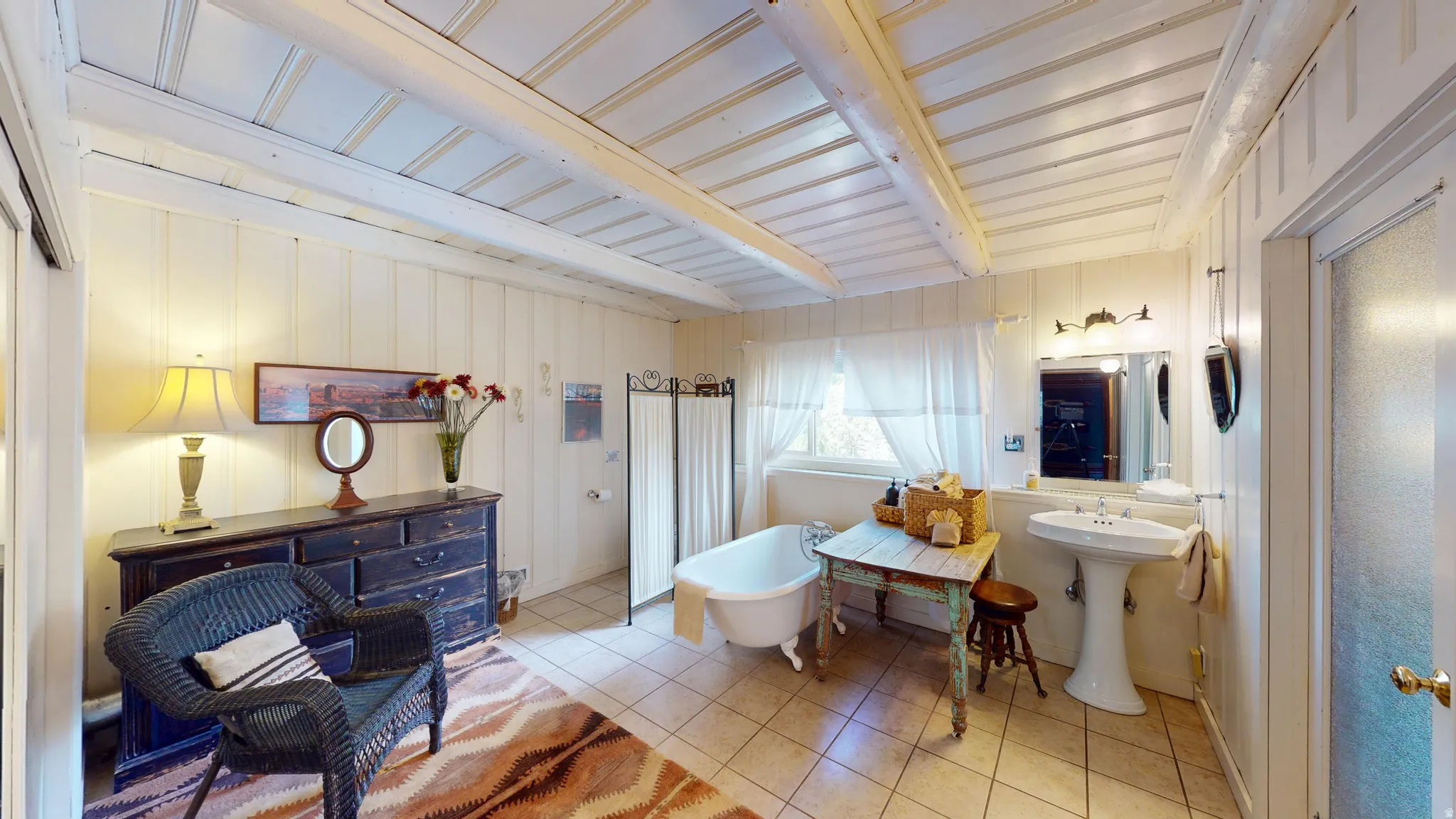 Bathroom featuring light tile patterned floors and a freestanding bath
