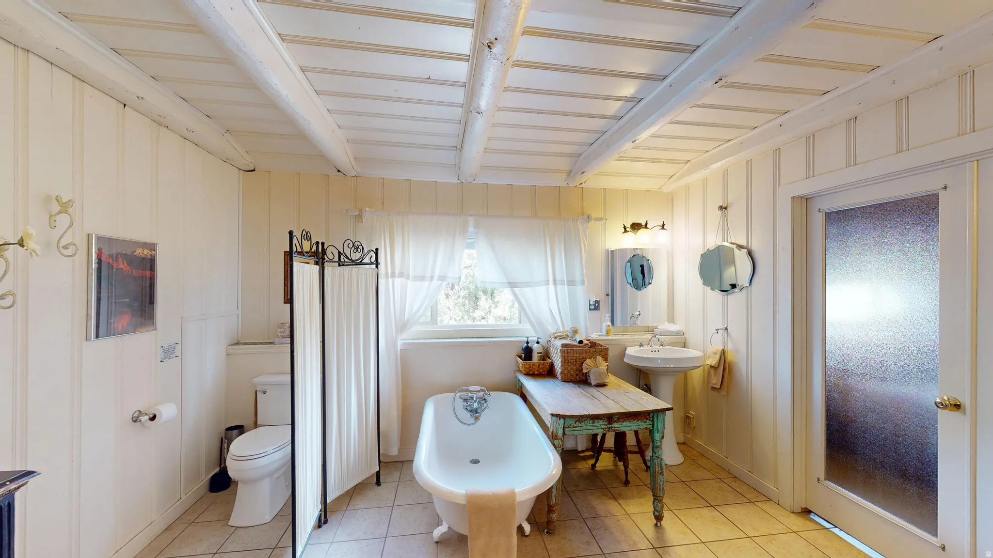 Bathroom featuring a freestanding tub and light tile patterned floors
