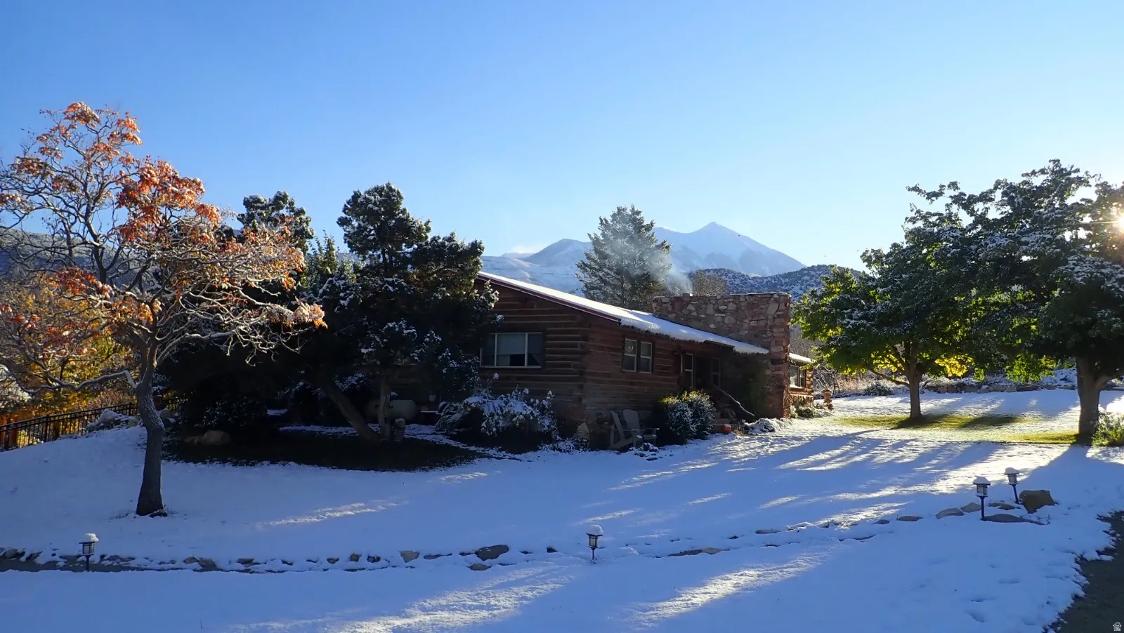 View of side of property featuring a mountain view and a chimney