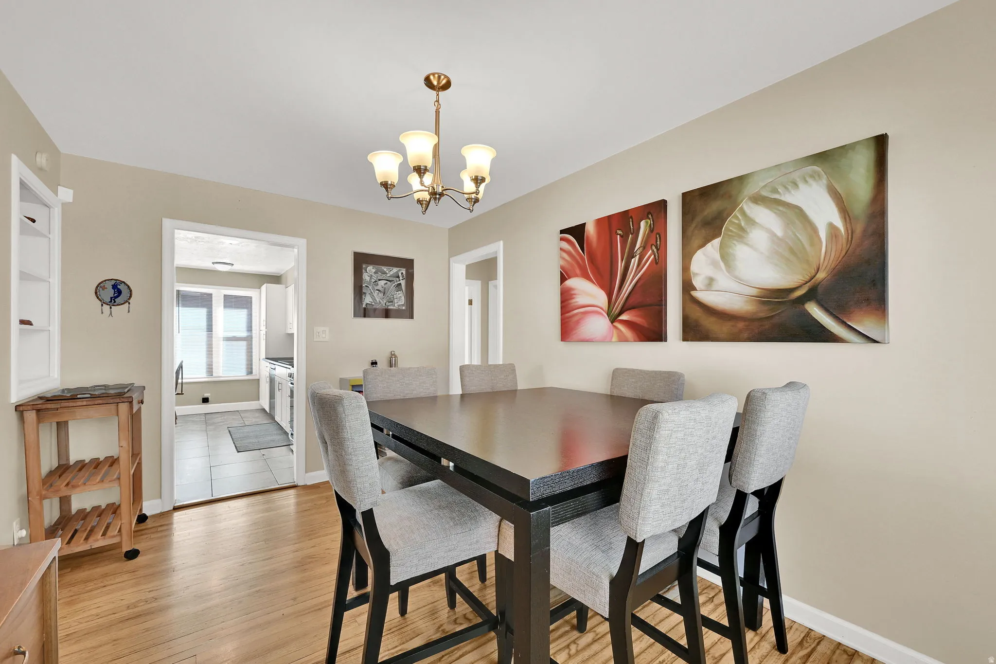 Semi-formal dining space featuring wood flooring and a chandelier