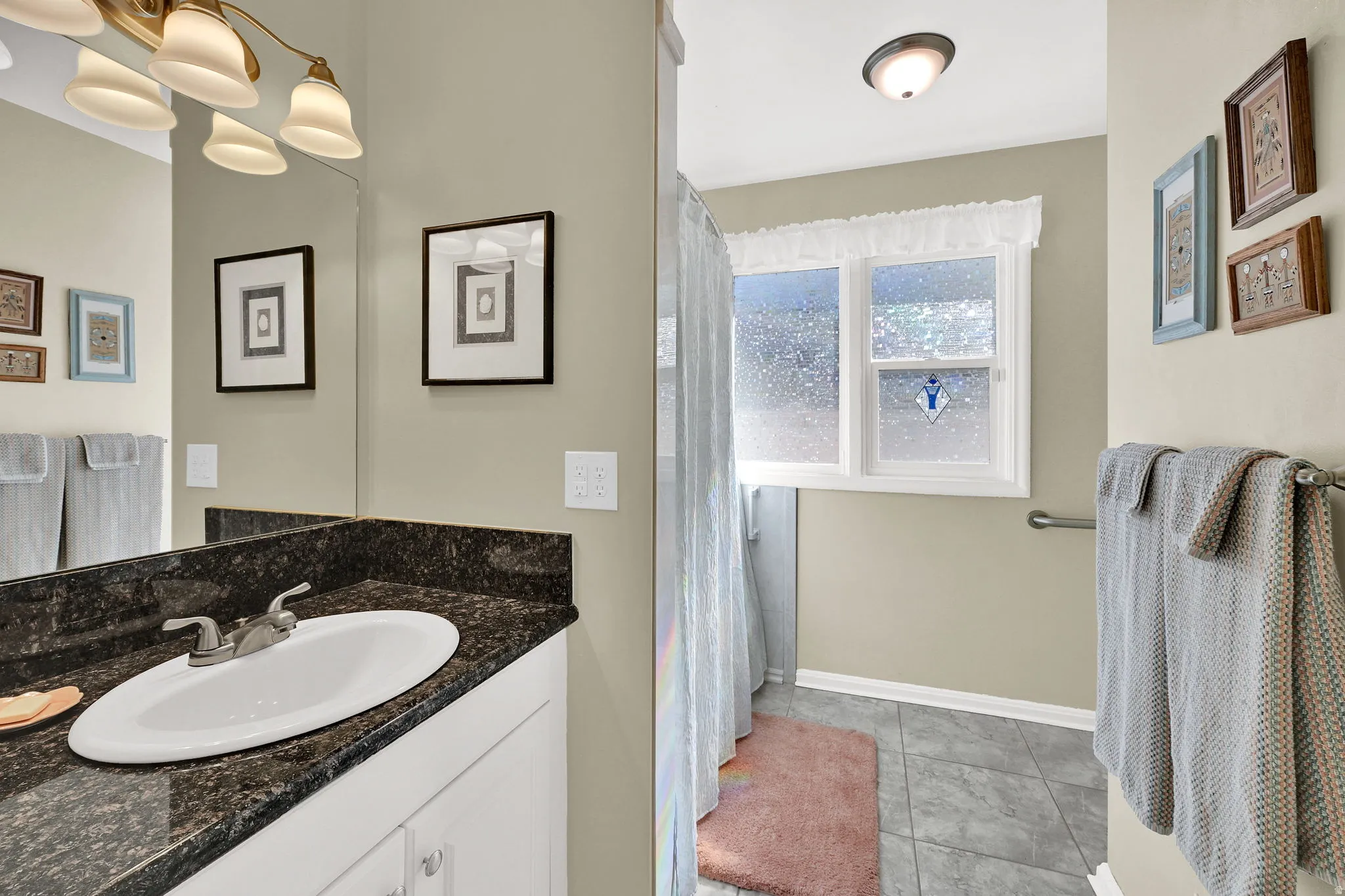 Full Bathroom with vanity, curtained shower, and storage